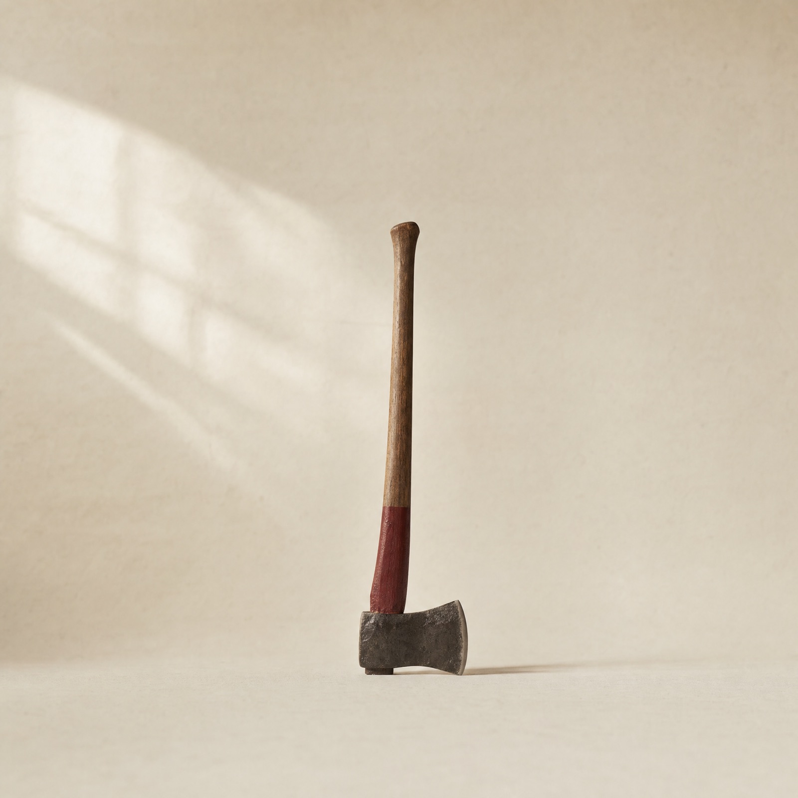 No. 01 Felling Axe — hand-forged steel head on a hickory handle with an oxblood-painted band